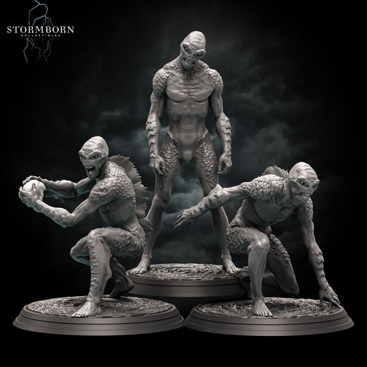 A set of three 32mm Medium Drowner miniatures by Stormborn Collectibles: the left pose crouches with a human skull trophy, the middle pose stands upright in a predatory stalk, and the right pose lunges forward with webbed claws; all figures feature scaled aquatic detail and are mounted on 25mm rippling water scenic bases. Each Sold Separately.