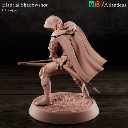 Rear-left angle of the elf rogue model highlighting the dynamic sweep of his cloak and the low-profile stance on the cobblestone display base.