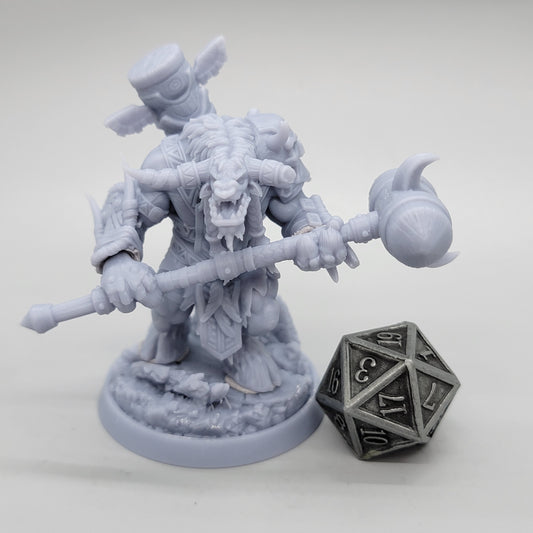 Unpainted minotaur gripping a long-handled hammer across its body, with another weapon carried on its back.
