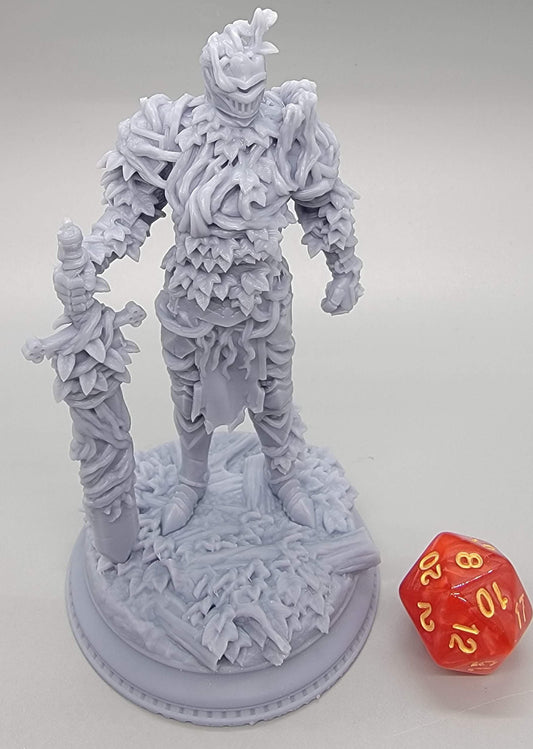 Forgotten Knights – Vine-Possessed Armor: A premium 75mm scale resin DIY miniature kit by D&K Custom Prints. This unpainted figure features a knight encased in thick, organic vines and leaf-covered plate armor, holding a massive overgrown greatsword. Shown with a red d20 for scale, this high-detail sculpt is designed for D&D, Pathfinder, and hobby painters. (Pictured is Pose 3)