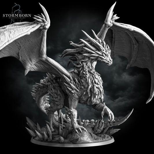 Right three-quarter view of the Gargantuan Frost Dragon resin miniature perched on an ice crystal base by Stormborn Collectibles.