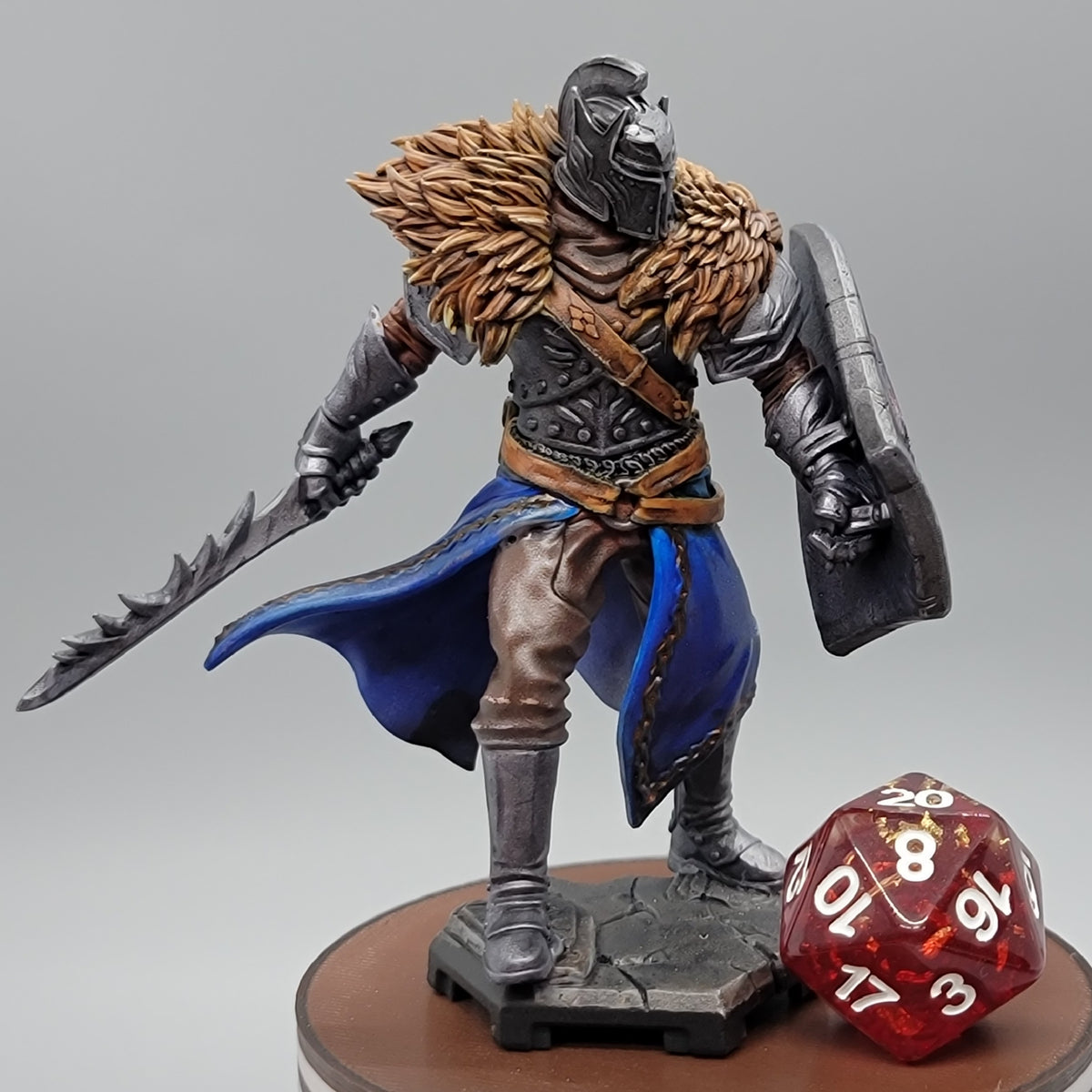 Custom Painted 32mm scale variant of Griff the Knight Human Fighter carrying a jagged sword and shield beneath a heavy fur mantle.