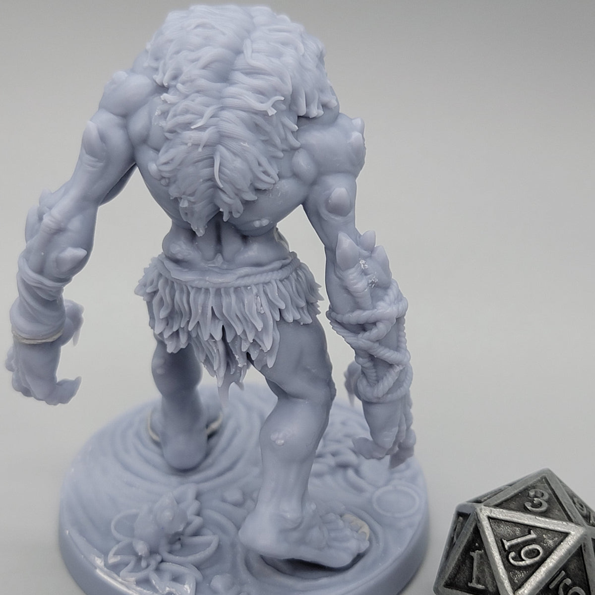Rear view of unpainted Hag Cursed Troll 1 with empty hands, muscular arms, and ragged clothing.