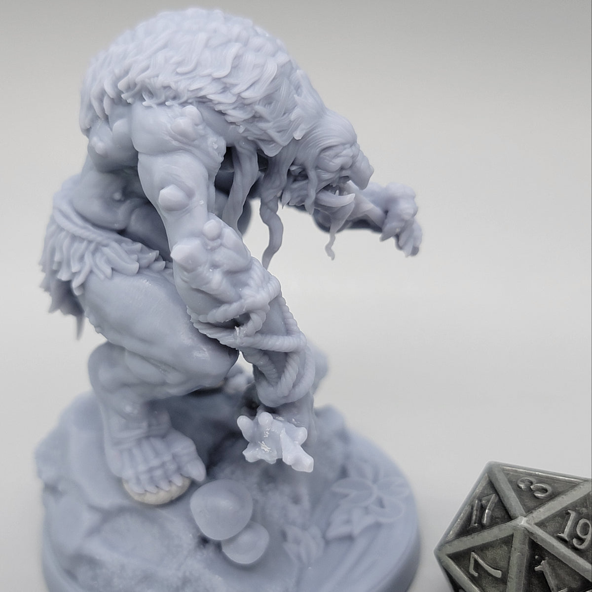 Side view of unpainted Hag Cursed Troll 2 showing its hunched posture, hands, wooden club, and scenic base.