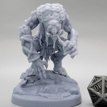Front view of unpainted Hag Cursed Troll 2 with oversized hands and a textured scenic base.