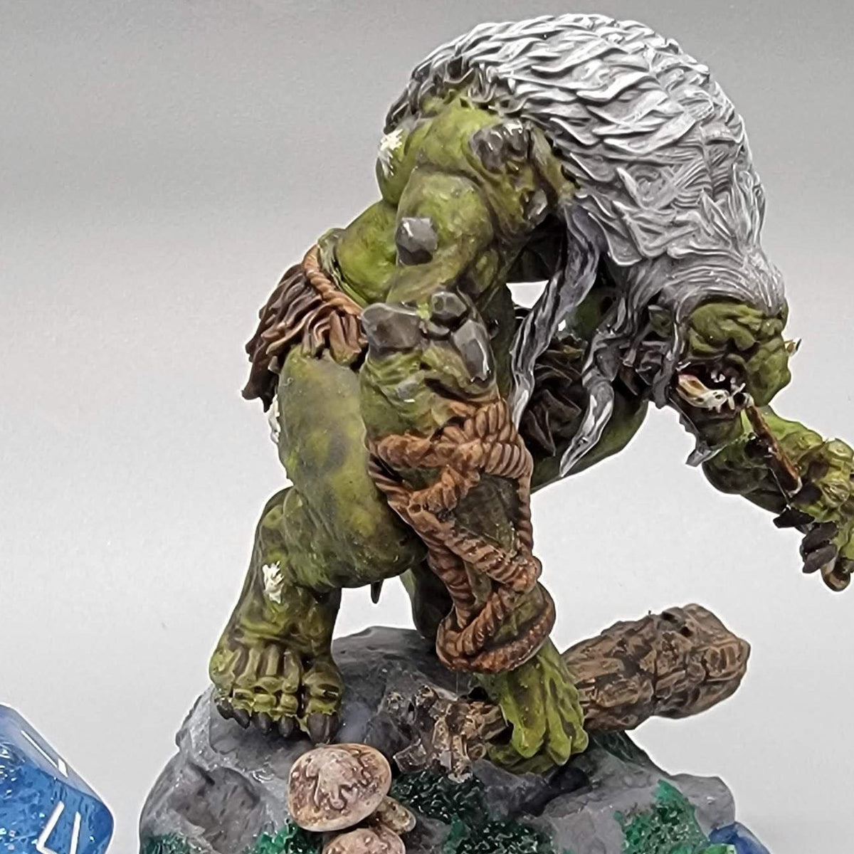 Angled view of painted Hag Cursed Troll 2 with green skin, pale hair, and oversized hands over a scenic base.