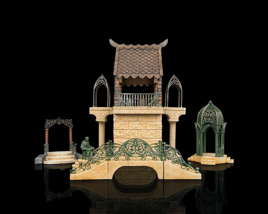 A complete set of painted high elven tabletop terrain props including a chapel, bridge, portal arch, shrine, and tower on a black reflective surface.