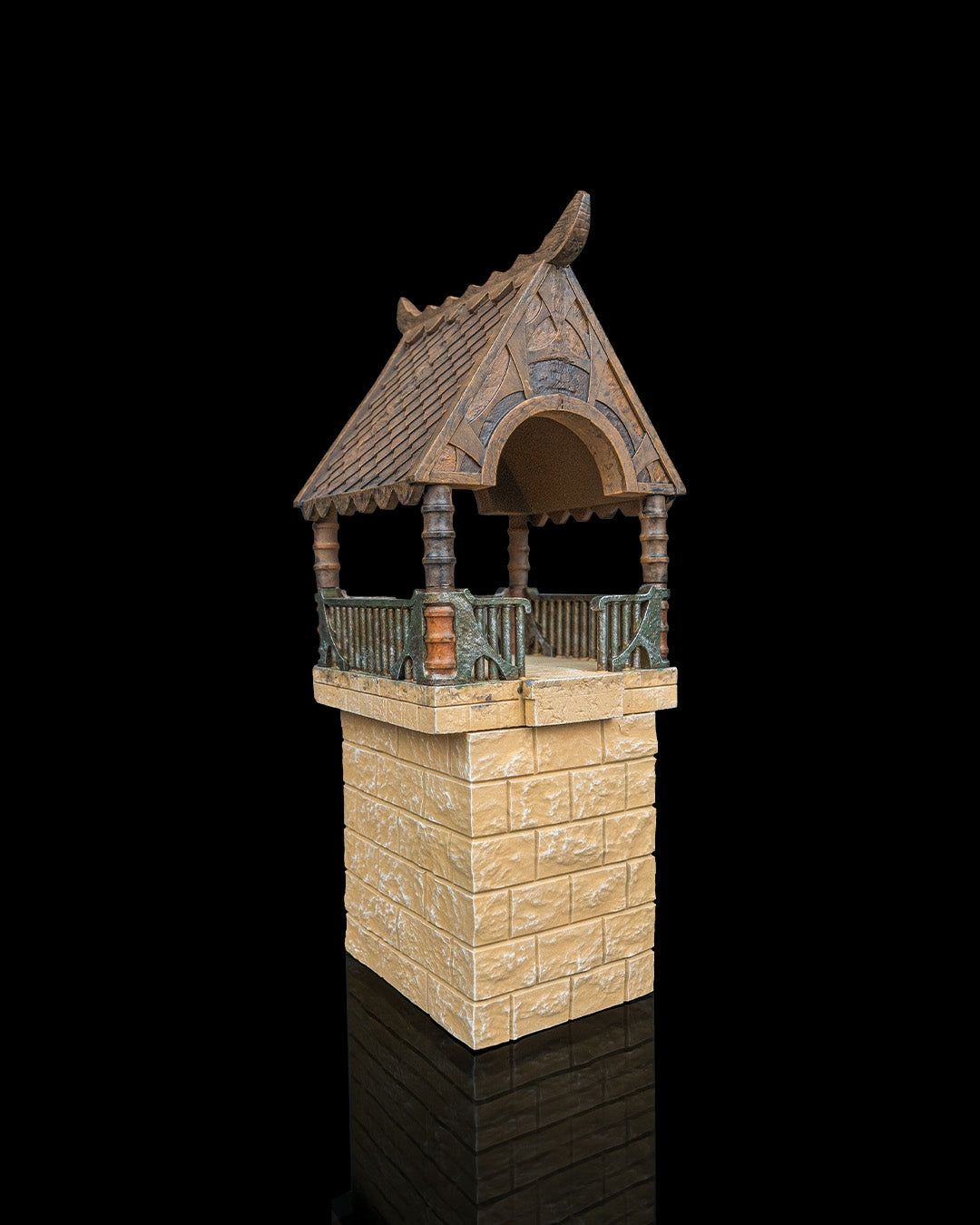 Close up of an elven watchtower resin terrain kit with stone brick base, mid floors, and multi-part wooden tiled roof structure.