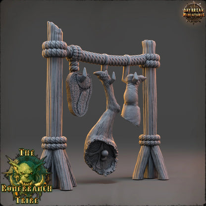 Human Meat Hanger dark fantasy terrain showing suspended remains and a rope-bound timber frame.