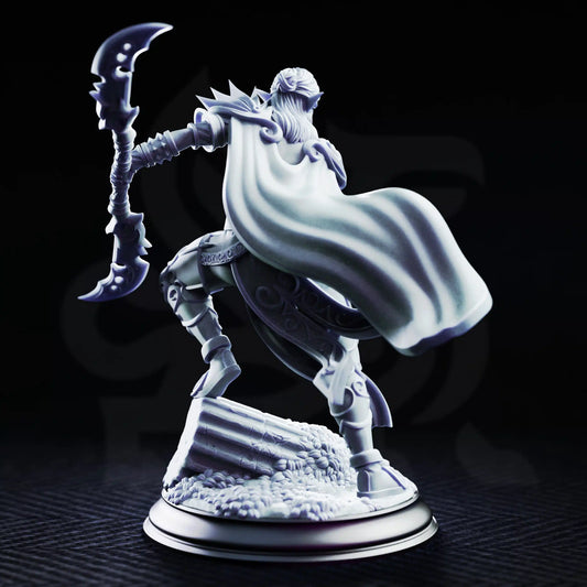 Rear view of Ilyara Deri Drow assassin miniature showing her billowing cloak, spiked shoulder armor, crescent weapon, and scenic ruin base