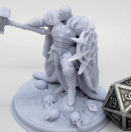 Invictus Lighthammer Human Paladin miniature with heavy plate armor, massive warhammer, radiant shield, and skull-strewn scenic base.