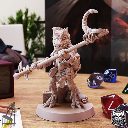 Kobold Spurt Collector by Dungeon Dog holding a scorpion-topped staff, with supply pouches and wooden crates.