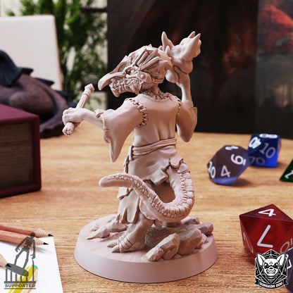 Rear angled view of Kobold Wizard miniature showing stitched robes, curved reptilian tail, wand, and raised magical effect.