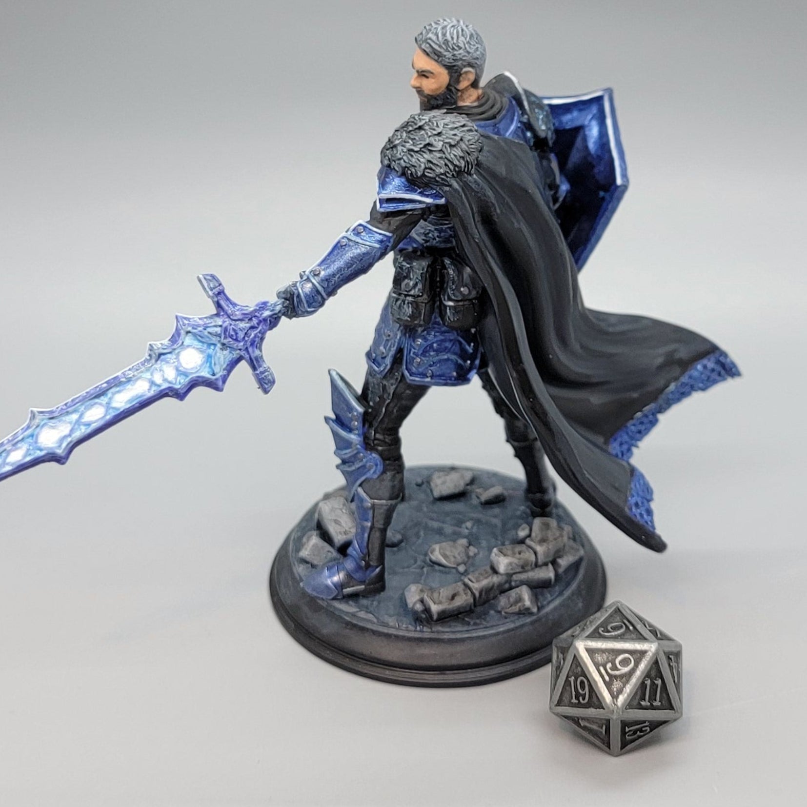 Side view of painted Lizarin Nordic Nature Paladin resin miniature holding runic sword and shield
