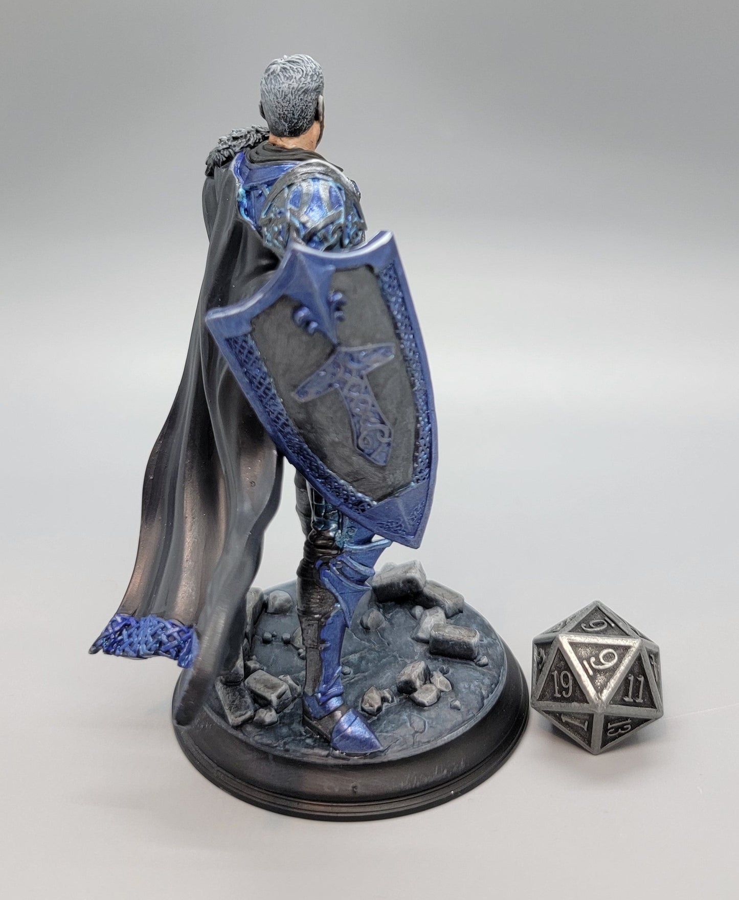 Back view of painted Lizarin Nordic Paladin miniature with cape, shield, and scenic base