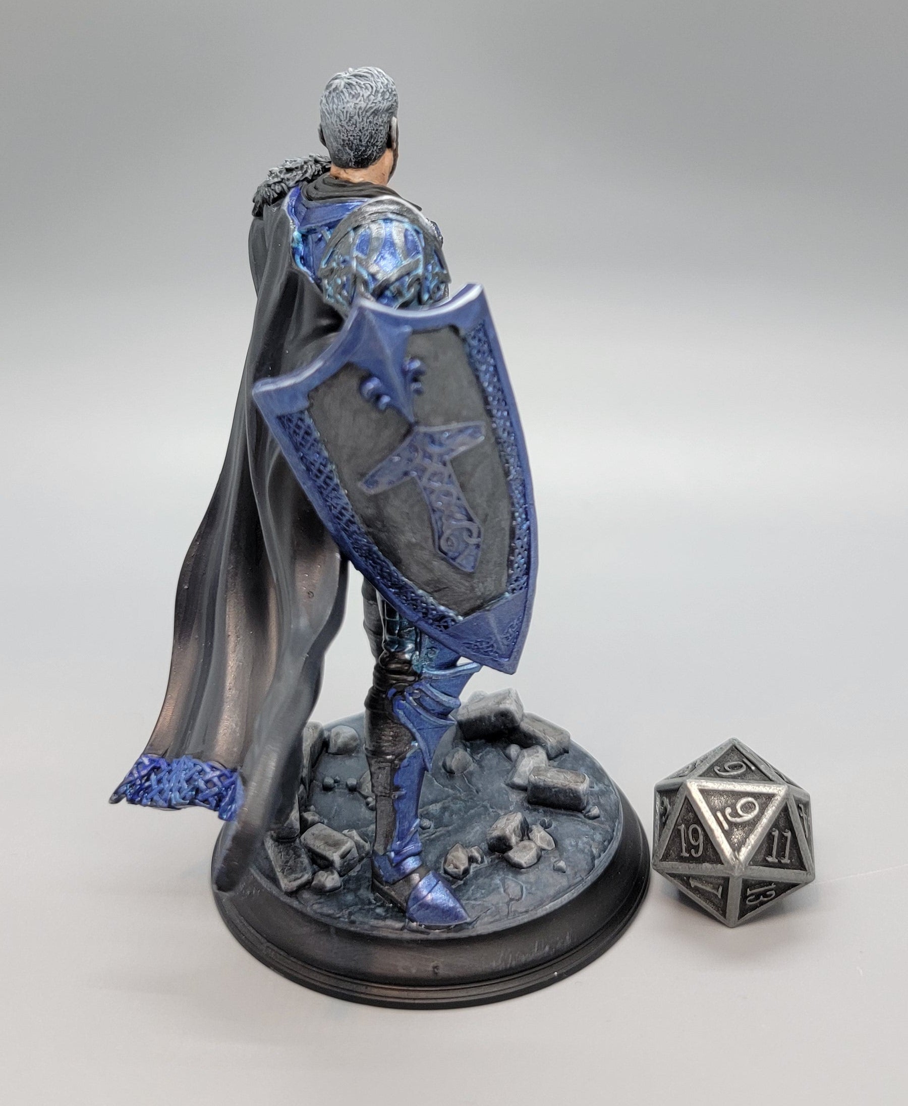 Back view of painted Lizarin Nordic Paladin miniature with cape, shield, and scenic base