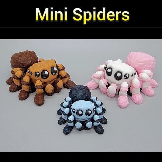 Three mini spider toys in brown, blue, and pink on a gray background with 'Mini Spiders' text above.