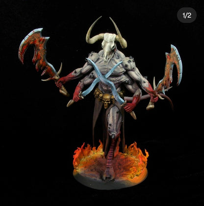 Front view of a pro-painted Moloch miniature featuring pale purple-gray flesh, red forearms, a bleached white animal skull head, and glowing orange flame bases.