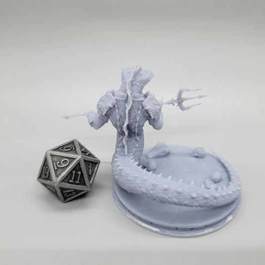Rear view of the printed Naga Serpent Warrior resin miniature showing the long coiled tail and base detail next to a metal d20 dice by Stormborn Collectibles.