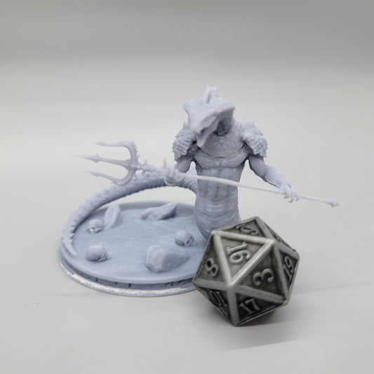 Front hero view of the printed Naga Serpent Warrior resin miniature with trident next to a metal d20 dice by Stormborn Collectibles.