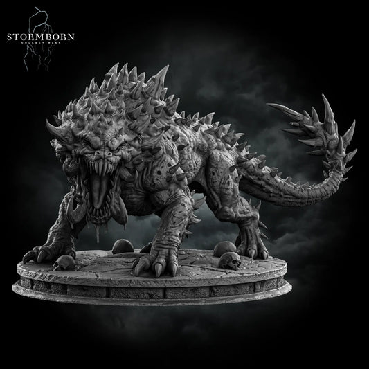 Front hero view of the Gargantuan Nightmare Beast resin miniature featuring an open roaring mouth, tusks, spiky hide, and scenic skull base by Stormborn Collectibles.