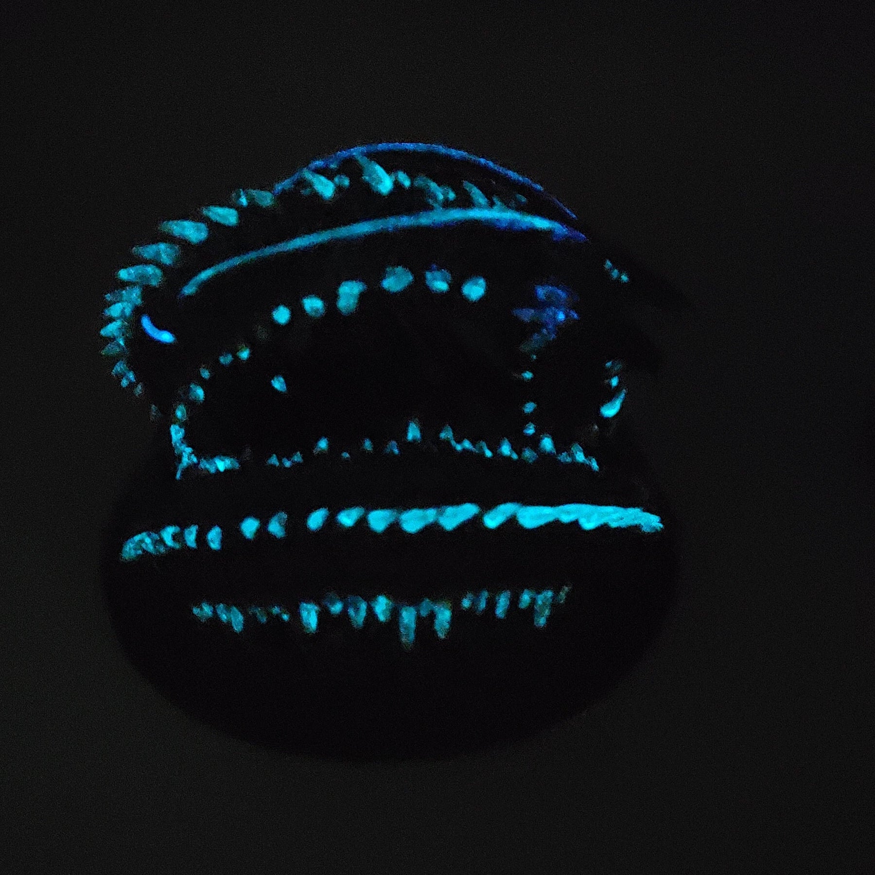 Glow effect photo of Old Mawgrin sea serpent miniature showing blue glowing details in the dark