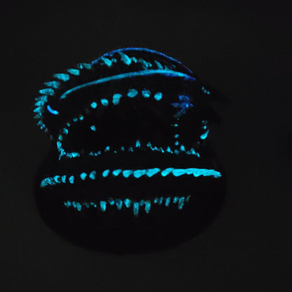Glow effect photo of Old Mawgrin sea serpent miniature showing blue glowing details in the dark