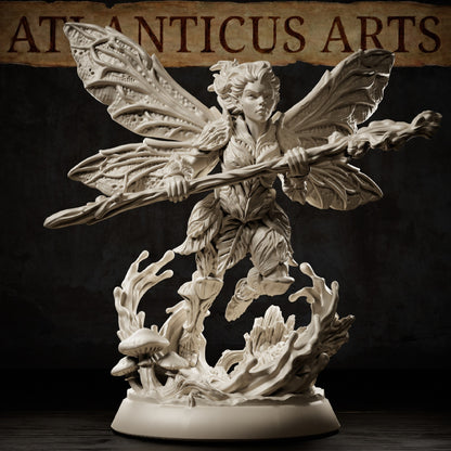 Pixie resin miniature flying above a woodland base with four patterned wings, twisted wooden staff, leaf clothing, mushrooms, and fallen tree details.