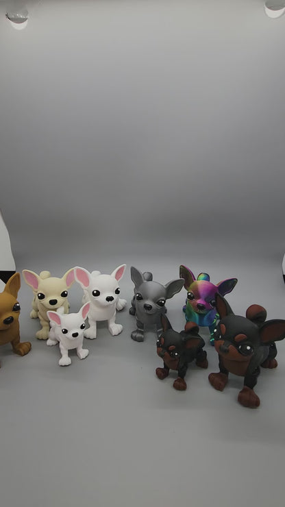 Showcase of multiple small chihuahua toys in various brown & greyscale colors plus a rainbow one.