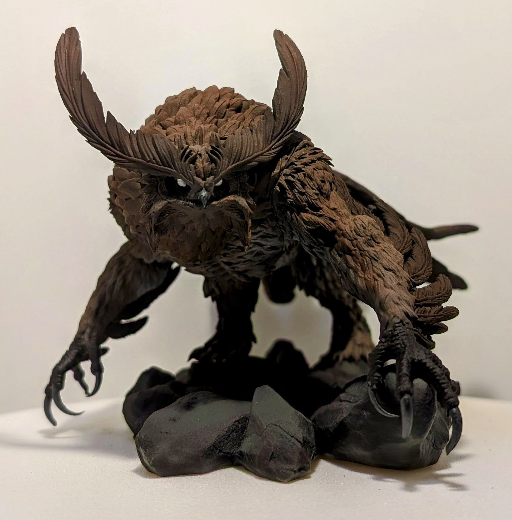 3D printed Titancrest Owlbear resin monstrosity with layered feathers and sharp talons posed on a rocky base