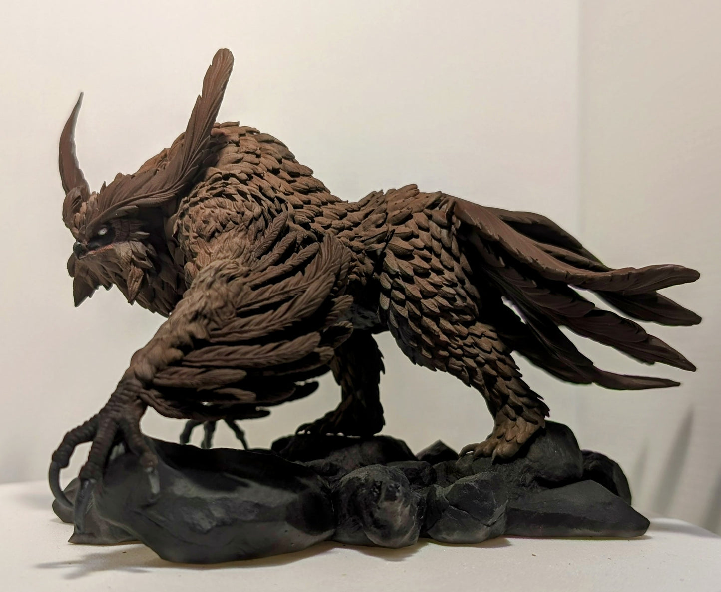 3D printed Titancrest Owlbear resin monstrosity with layered feathers and sharp talons posed on a rocky base