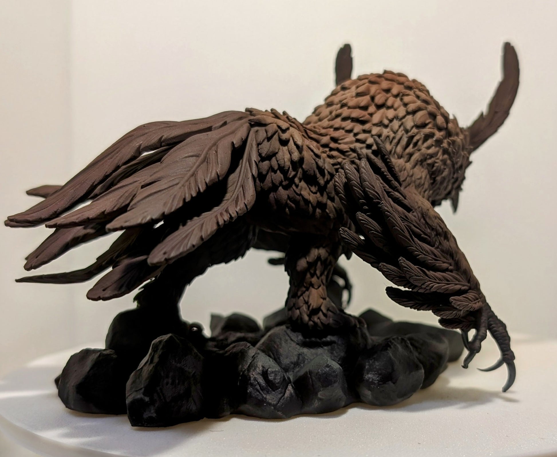 3D printed Titancrest Owlbear resin monstrosity with layered feathers and sharp talons posed on a rocky base