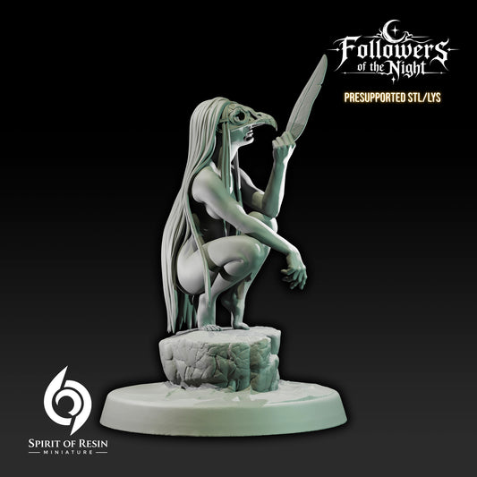 Side view of Sarin Night Daughter Human Druid miniature crouched on a rocky perch while holding a large feather.