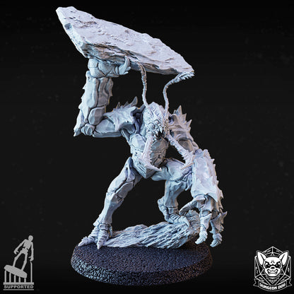 Front view of variant A huge-sized insectoid miniature holding a large stone slab over its head.