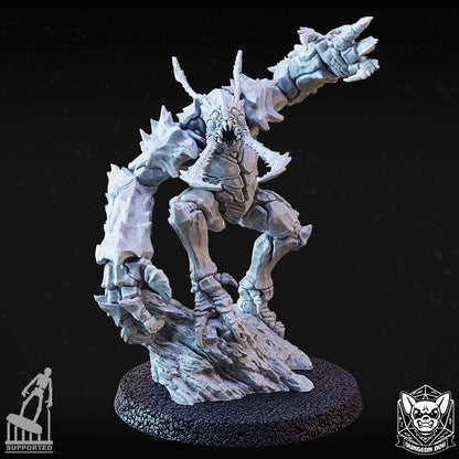 Front dynamic view of variant B chitinous cavern monster mini lunging forward on rocky terrain.