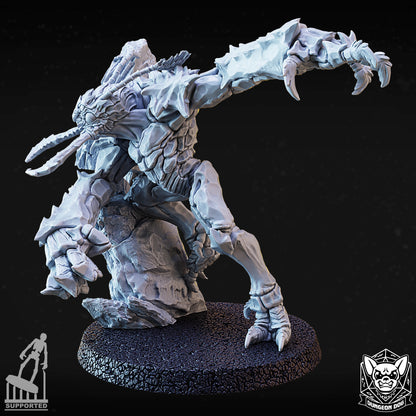 Angled side view of the wall-bursting variant D beast miniature showing the reverse of the broken rock terrain.