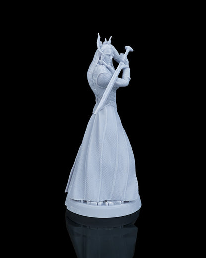 Right side profile view of the unpainted resin elf miniature showcasing the long flowing hair and the reverse side of the blade.
