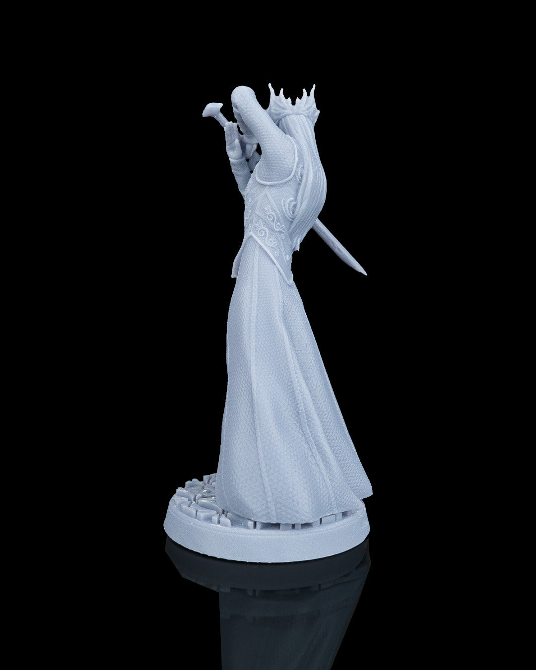 Left profile view of the unpainted resin elven king miniature showing the layered back armor and pommel of the sword.