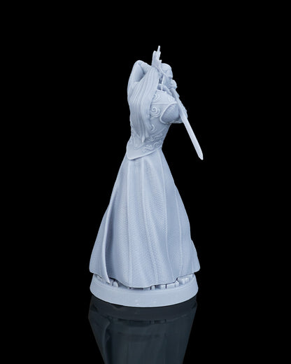 Rear view of the unpainted resin elven noble miniature showing the smooth fabric folds of his formal floor-length robes.