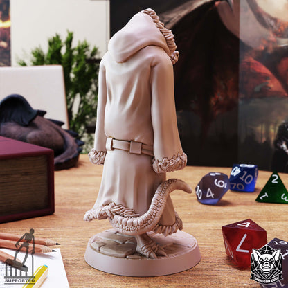 Rear view of Three Kobolds in a Trenchcoat miniature showing the long hooded coat, fur trim, and reptilian tail.