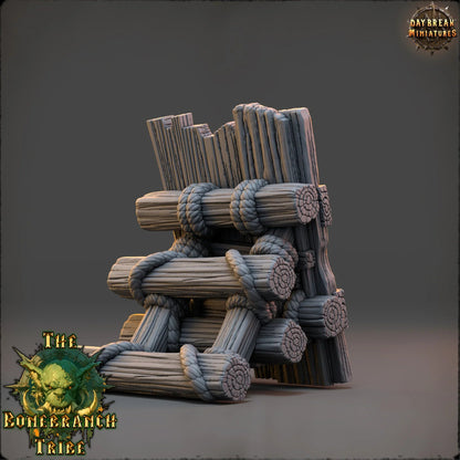 Rear view of the Thumper Board terrain prop showing stacked log supports and rope-bound construction.