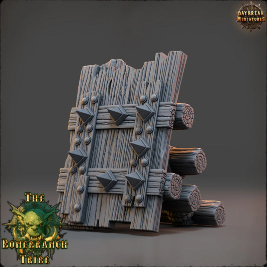 Thumper Board scatter terrain prop made from rough wooden planks, stacked logs, rope bindings, and metal spikes.