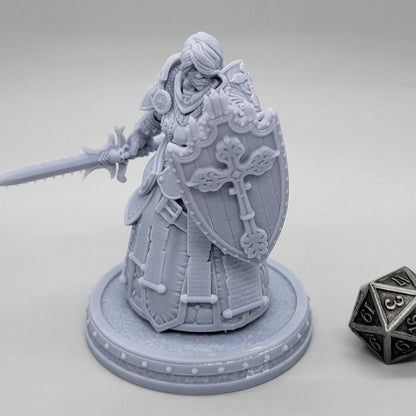Thyra Malenholt Human Barbarian miniature in heavy armor holding a one-handed sword and large shield.