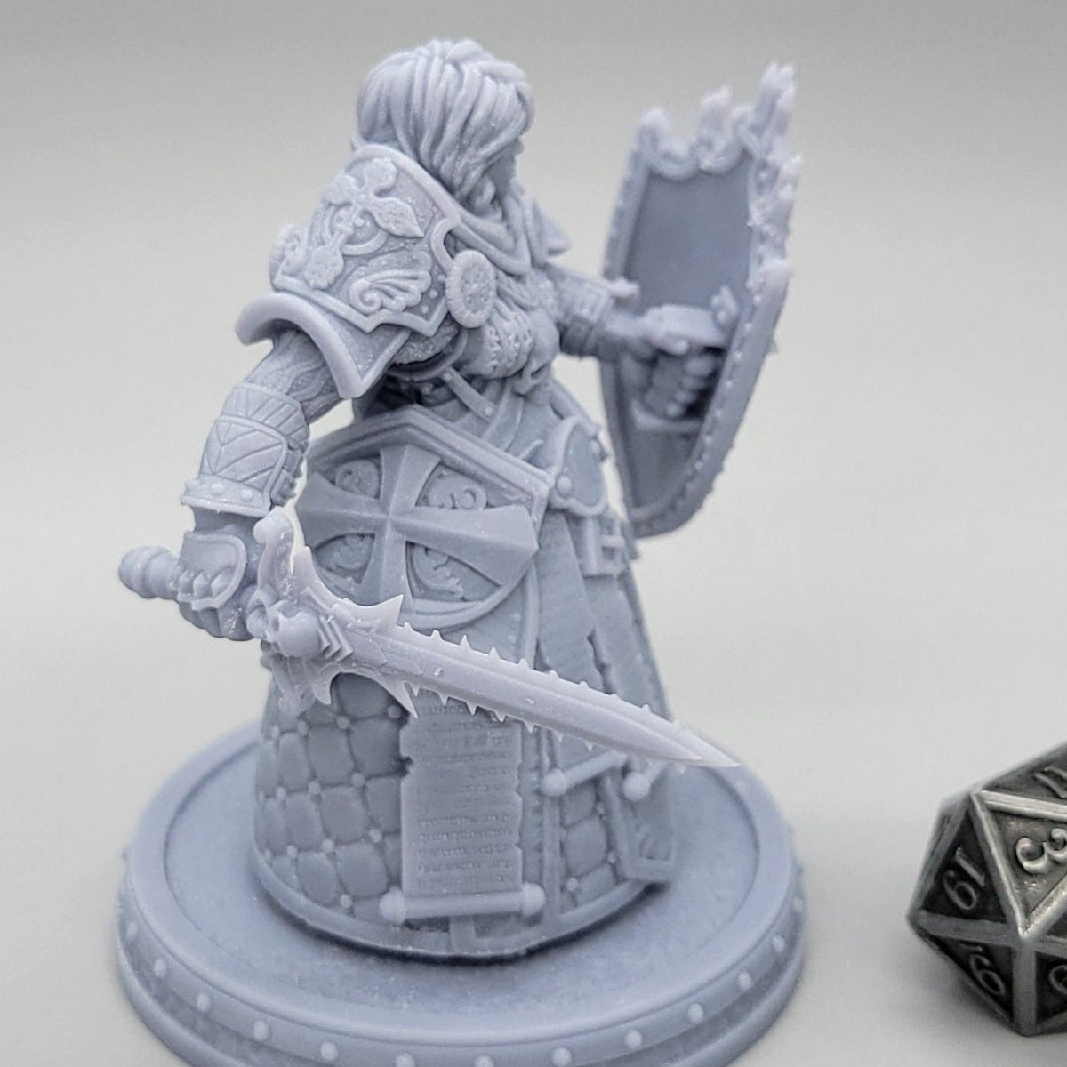 Thyra Malenholt Human Barbarian miniature in heavy armor holding a one-handed sword and large shield.