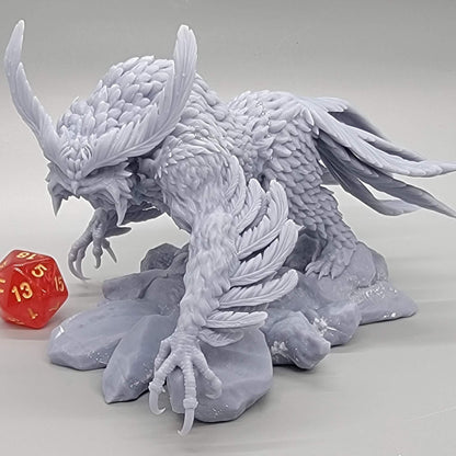 Angle view of the printed Titancrest Owlbear resin figure next to a dice for scale by Stormborn Collectibles.