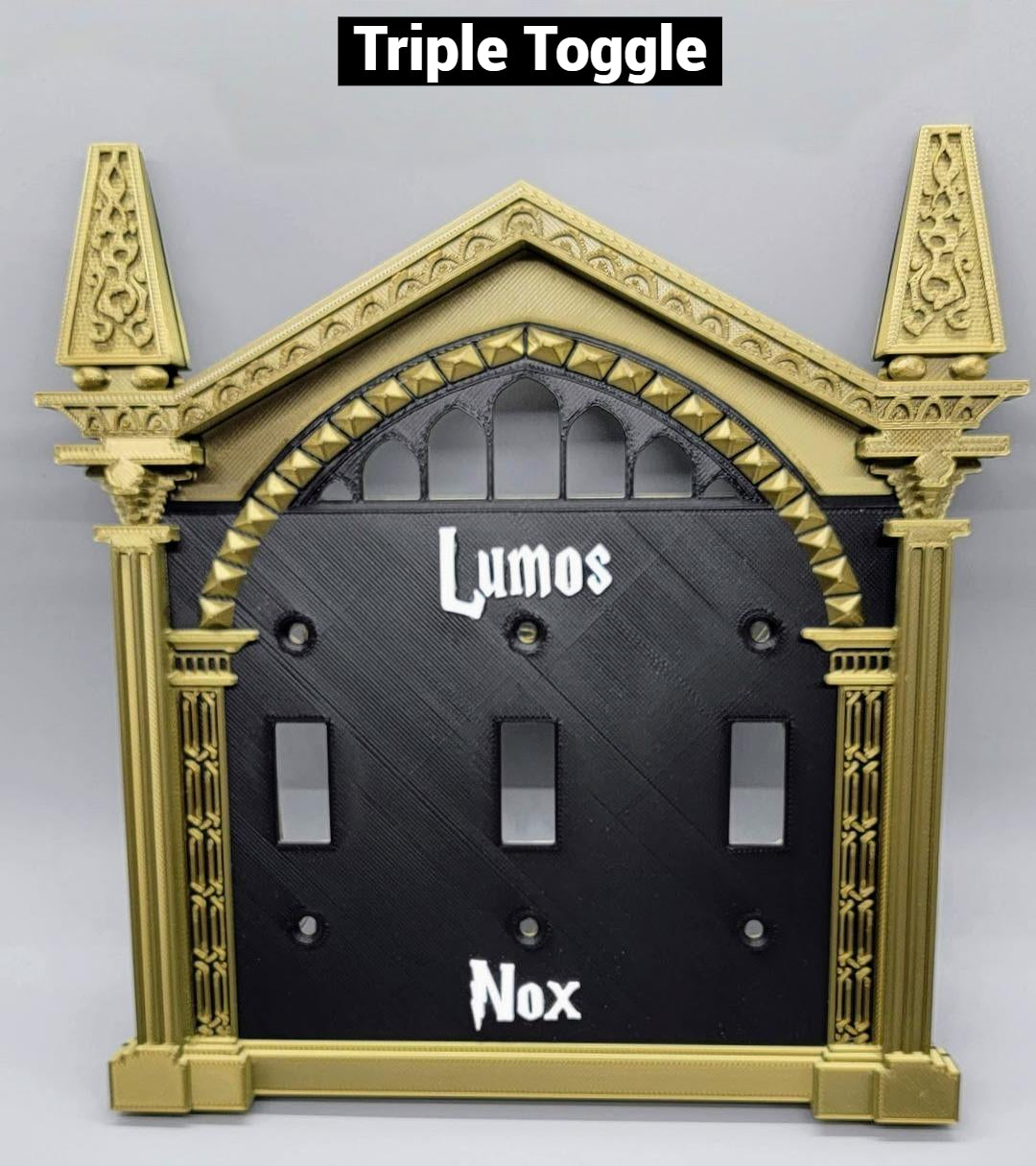 Triple toggle wizard light switch cover with bronze frame, black plate, and white Lumos and Nox lettering for wall plate decor