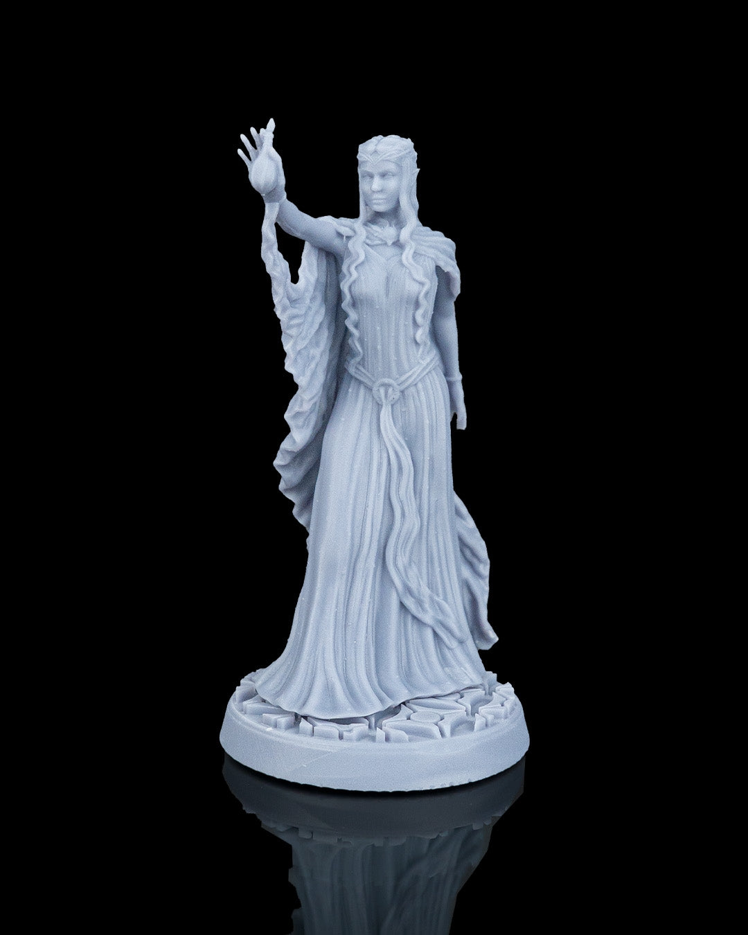 Three-quarter front view of the Valyra miniature showcasing the runic details engraved on the circular base and the overall regal posture of the elven queen.