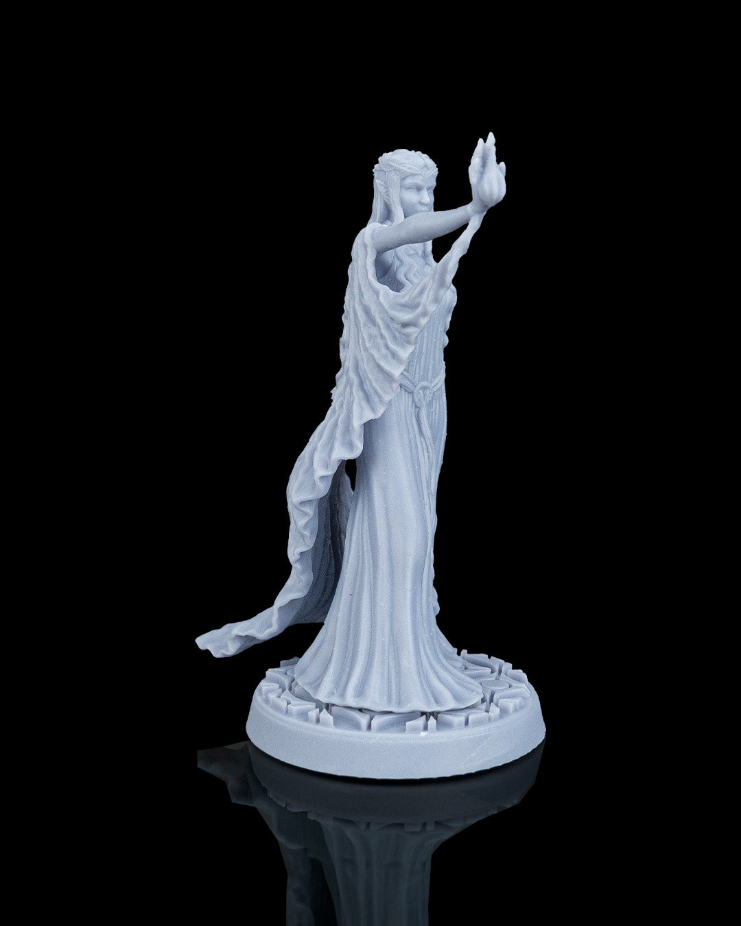 Right side profile view of the Valyra elven miniature, emphasizing the forward stretch of her spellcasting arm and the elegant folds of her long flowing gown.