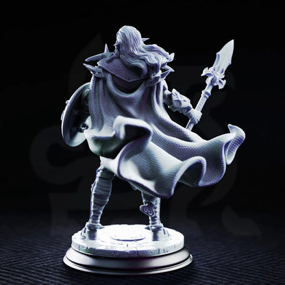 Rear view of Vessels of Irinax Drow Soldier 1 showing long hair, a billowing cloak, spiked armor, spear, shield, and stone base