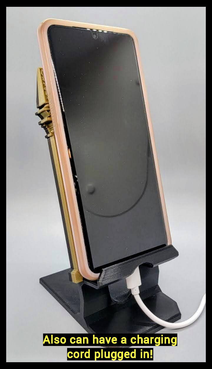Wizard phone stand showing access for a charging cable plugged into the device through the phone holder ledge. Charging cord can also come through the back for phone charging access as well.
